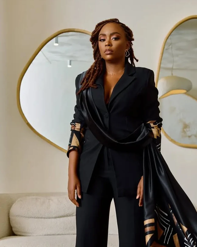 Maureen Ayité, fondatrice de Nanawax, en tailleur noir et étole bogolan